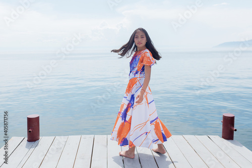 A girl of Buryat appearance on Lake Baikal photo