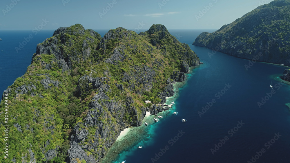 Tropic highland islands with green forest on rocks at sea gulf aerial view. Nobody nature landscape of El Nido Islets, Philippines, Visayas Archipelago. Vacation at paradise isles at summer day