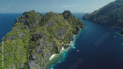 Tropic highland islands with green forest on rocks at sea gulf aerial view. Nobody nature landscape of El Nido Islets, Philippines, Visayas Archipelago. Vacation at paradise isles at summer day