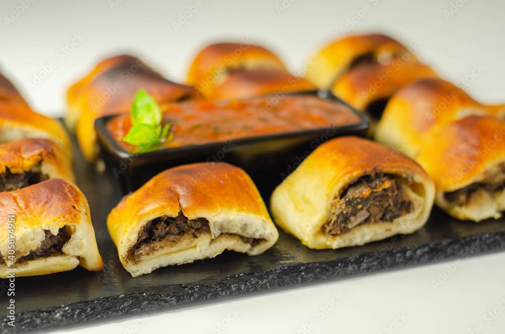 Patty's pies stuffed with minced meat, mushrooms and onion, served with sauce
