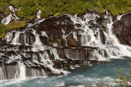 Hraunfossar waterfalls cascading into the Hvítá river over ledges of lava rock
