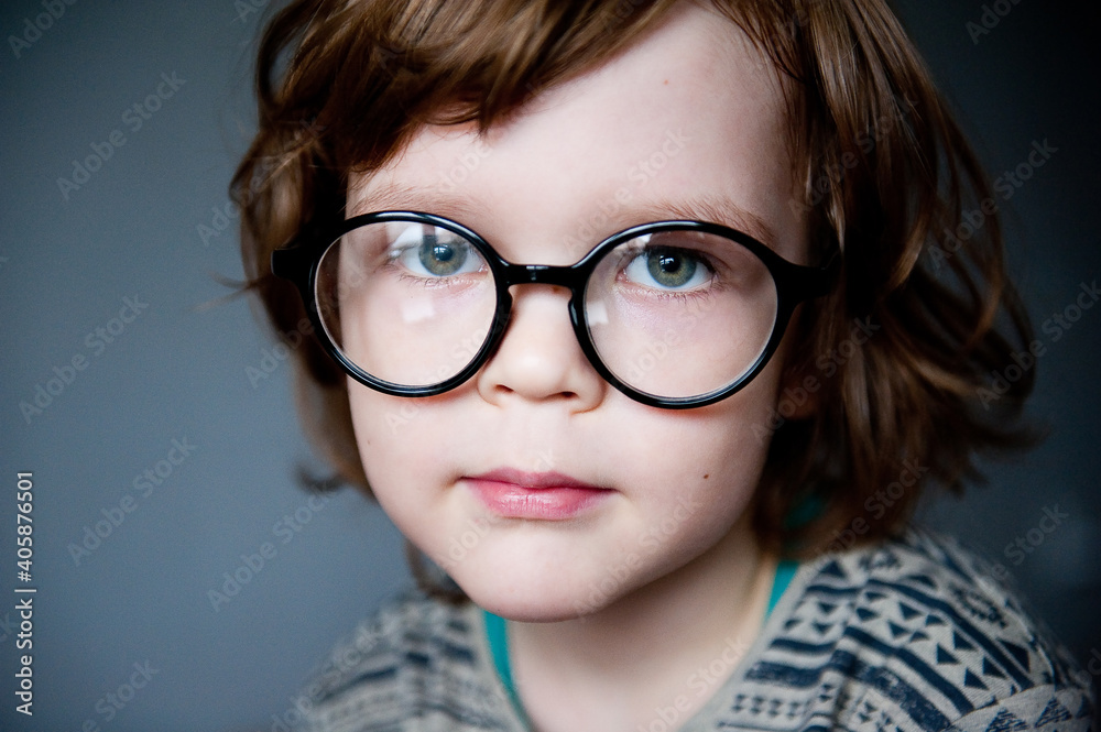 Portrait of a cute child in vision-correcting glasses.