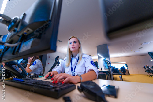 Female security operator working in a security data control room offices