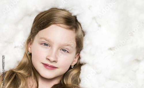 Portrait of a girl in the clouds. Child on a white background.