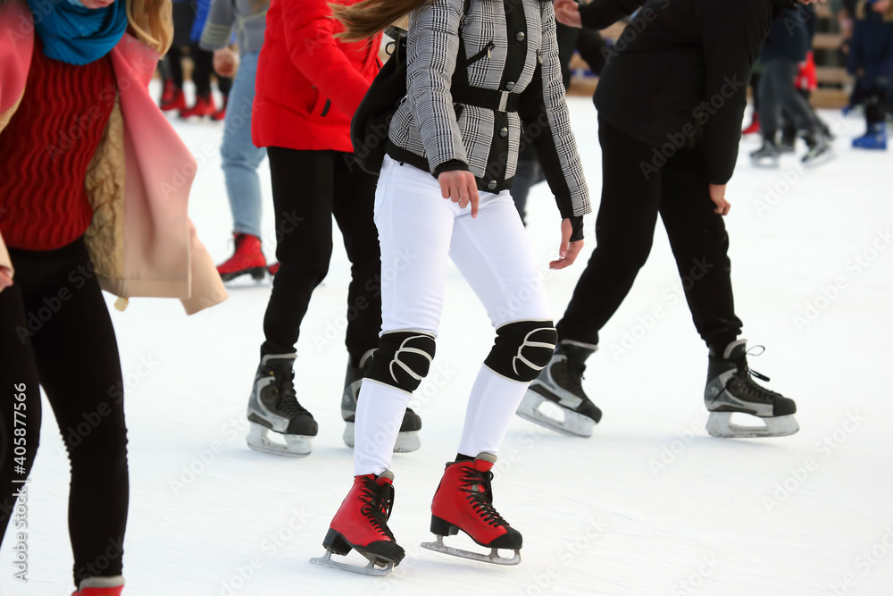 different people are actively skating on an ice rink. hobbies and leisure. winter sports different people are actively skating on an ice rink. hobbies and leisure. winter sports