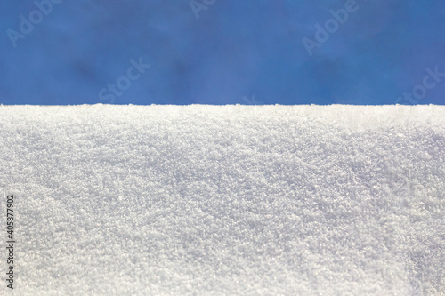 In clear sunny weather, clean snow background against the blue sky