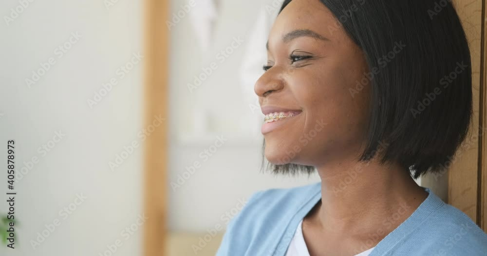 African american woman smiling with braces at home African american woman smiling with braces at home