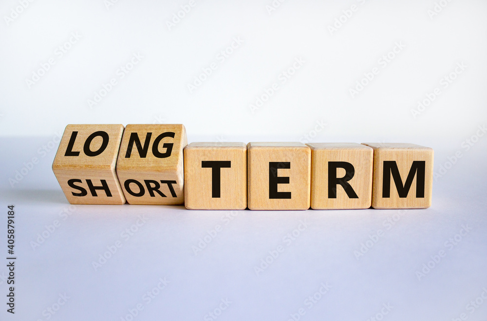 Long or short term symbol. Turned cubes and changed words 'short term' to 'long term'. Beautiful white background. Business and long or short term concept, copy space. Long or short term symbol. Turned cubes and changed words 'short term' to 'long term'. Beautiful white background. Business and long or short term concept, copy space.