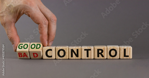 Bad or good control symbol. Businessman turns wooden cubes and changes words 'bad control' to 'good control'. Beautiful grey background. Business and good control concept. Copy space.