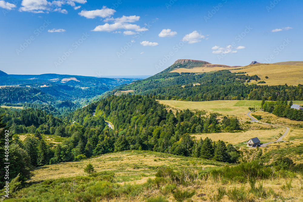 Fototapeta premium the landscape between the small town of Chambon sur le Lac and Mont Dore, in Auvergne (France). Hills and meadows as far the eye can see
