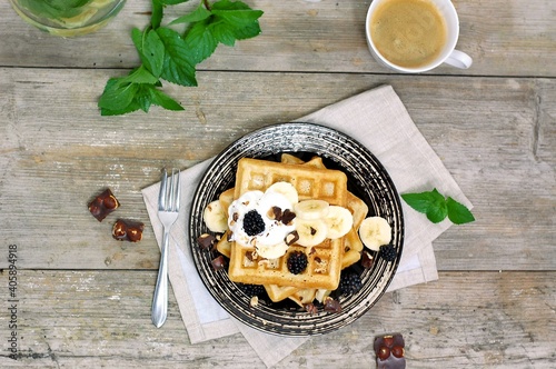 Whole grain waffles with chocolate, banana, cottage cheese, milk, coffee