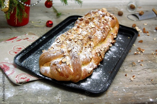 Christmas cake with almond and sugar on glack plate photo