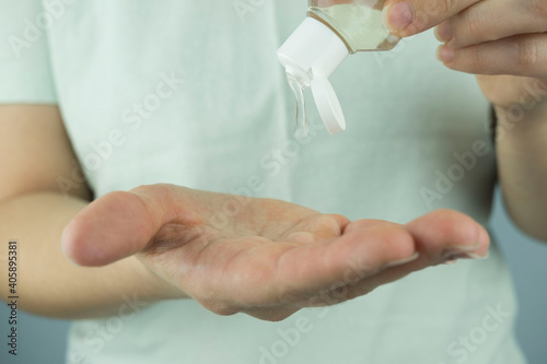 Personal Hygiene: Liquid Gel Soap Hand Sanitizer Pouring from Bottle into a Woman's Hand isolated