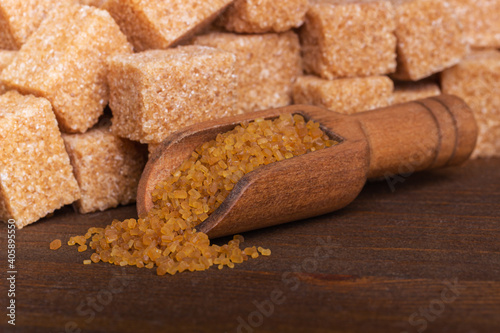 Brown cane sugar in a wooden spoon macro