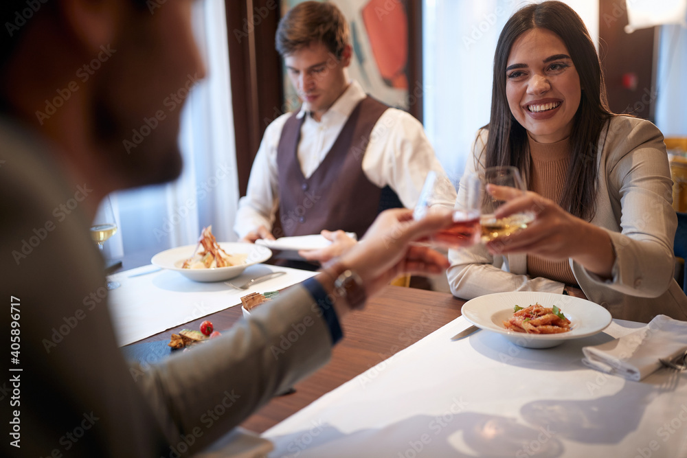 Colleagues toasting at a business lunch in the restaurant. Business, restaurant, lunch Colleagues toasting at a business lunch in the restaurant. Business, restaurant, lunch