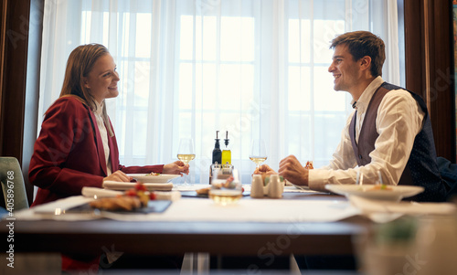 A young couple in love having a good time at lunch at the restaurant. Couple, love, restaurant, together