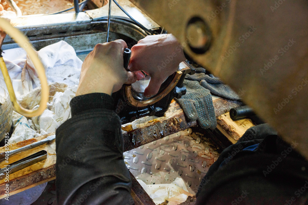 Fototapeta premium Repair of a diesel generator converted to gas.