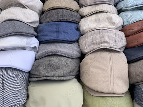 Cuadro en lienzo Neatly arranged pile of newsboy caps with different patterns in a shop