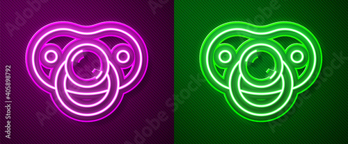 Glowing neon line Baby dummy pacifier icon isolated on purple and green background. Toy of a child. Vector.