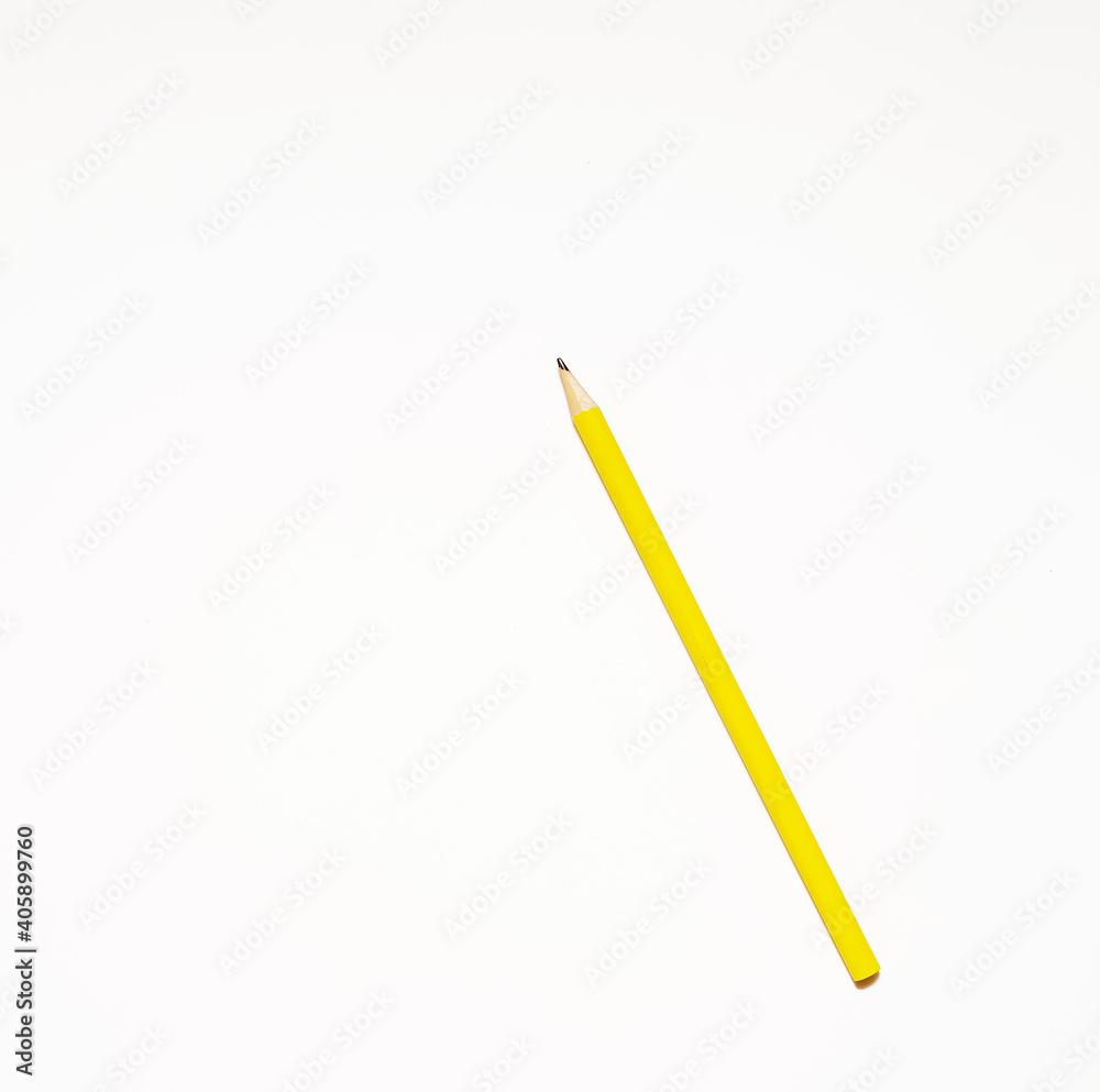 Presentation template with copy space by top view close up macro photo of wooden yellow pencil isolated on white paper that look minimalist and clean. Pencil on paper. Space for text.