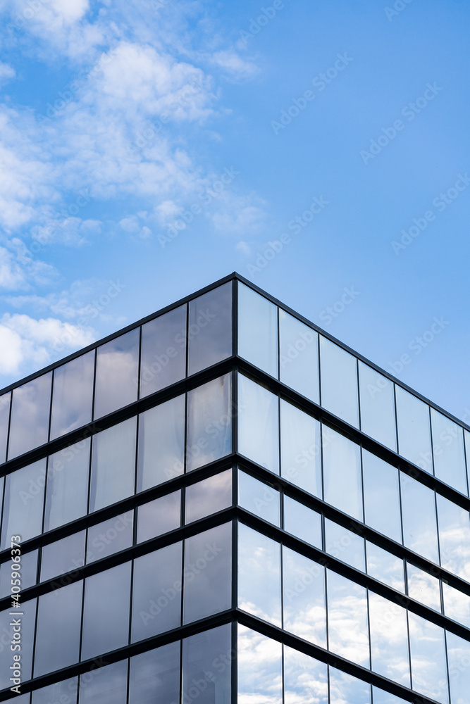 Modern Glass Building Architecture with blue sky and clouds Modern Glass Building Architecture with blue sky and clouds