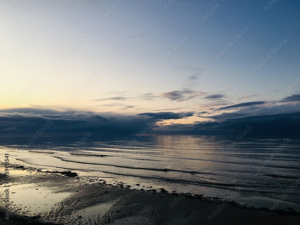 Scenic View Of Beach Against Sky During Sunset