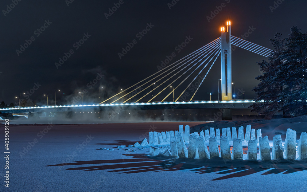 Obraz premium Open water ice swimming place at the Kemijoki river. Icicles on a blue background.