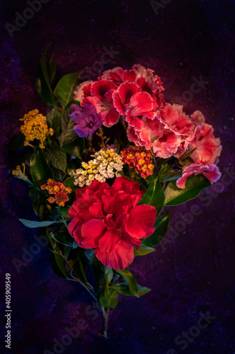 Some colored flowers on dark background.