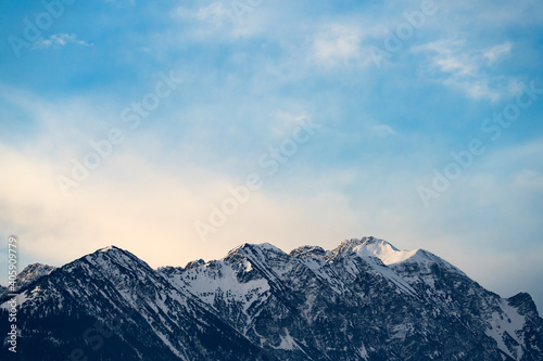 Mountain range around the Schwarzhanskarspitze with soft pastel-colored clouds at sunrise in Tyrol