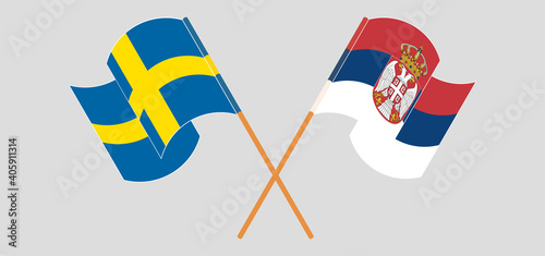 Crossed and waving flags of Sweden and Serbia