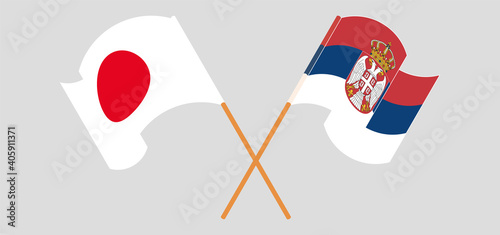 Crossed and waving flags of Japan and Serbia