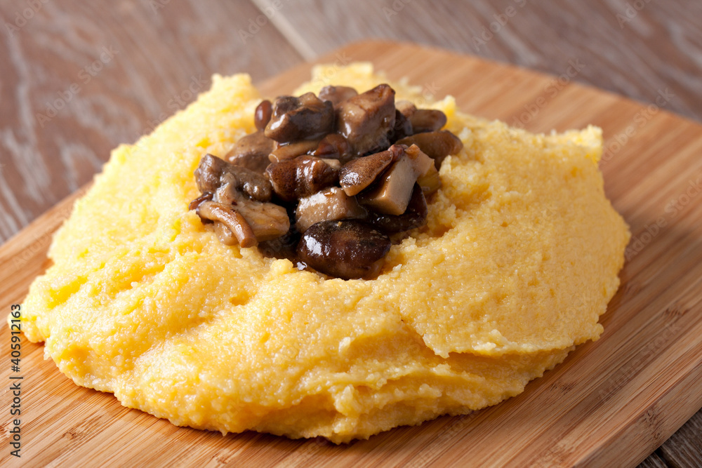 Polenta with mushroom. Traditional corn food in the plate. Polenta with mushroom. Traditional corn food in the plate.