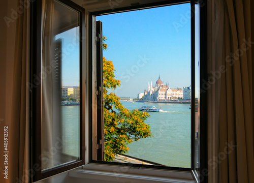 Photography View through an open window of the Budapest Parliament building along the Danube River, in Budapest Hungary