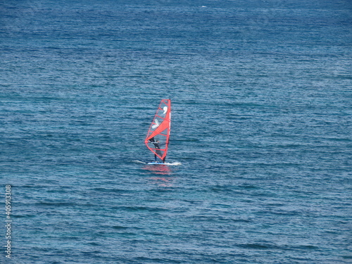 A man windsurfs in the Mediterranean sea in winter in Haifa, Israel.