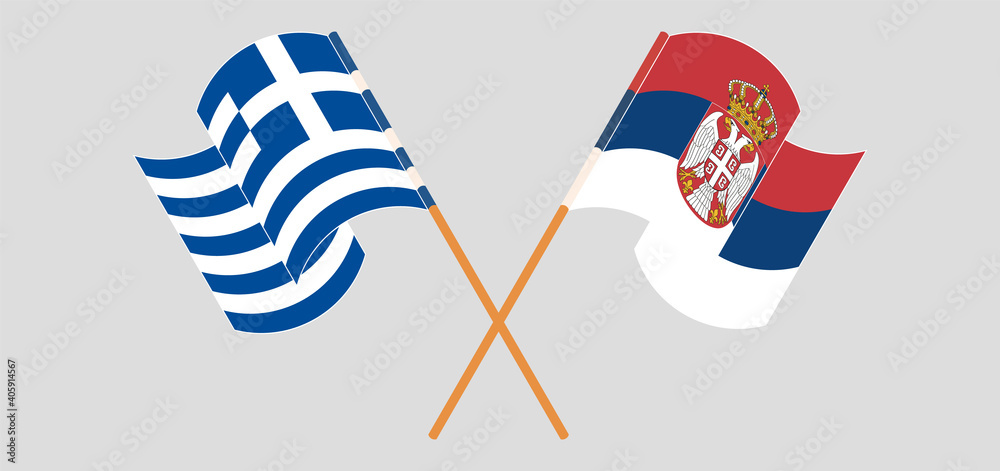 Crossed and waving flags of Greece and Serbia