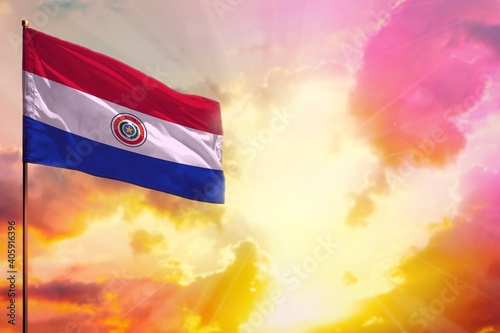Fluttering Paraguay flag in top left corner mockup with the space for your text on beautiful colorful sunset or sunrise background.