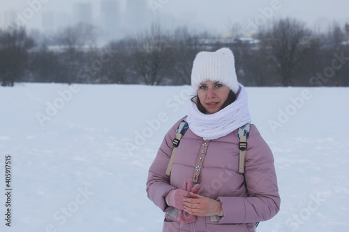 Woman in winter clothes on a walk in the park. There is a lot of snow around. © f2014vad