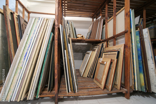 Fotografi Wooden shelves at art gallery storage full of pictures and art equipment
