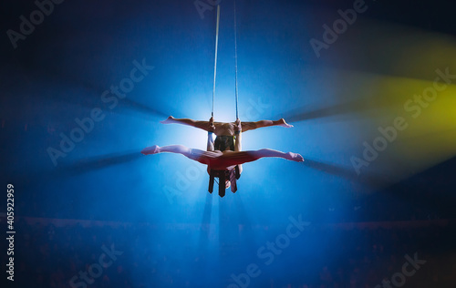 Fototapeta Naklejka Na Ścianę i Meble -  Circus actress acrobat performance. Two boys perform acrobatic elements in the air.
