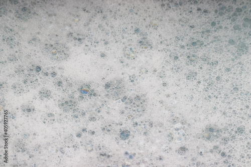 White foam with soap bubbles, selective focus