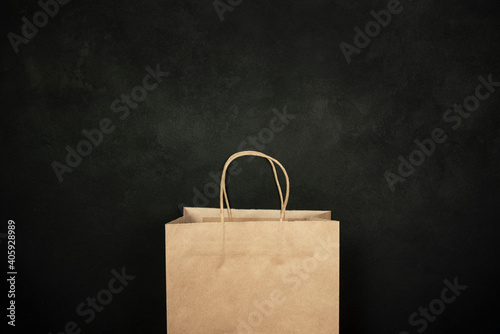 Paper bag for grocery shopping on a black background.
