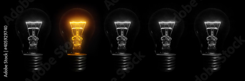 Tablou pe pânză incandescent light bulb on black background