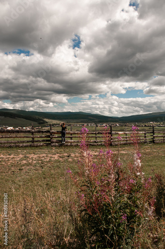 Beautiful landscape with cloudy sky, village and man