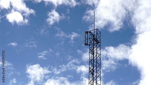 telecommunications antenna against cloud sky background