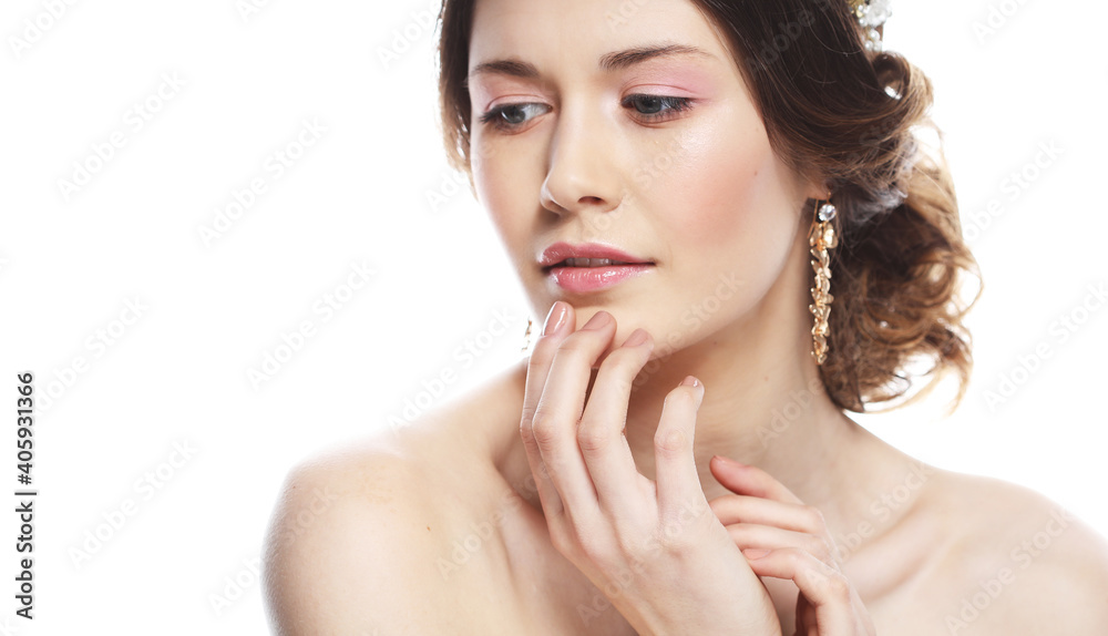 Fototapeta premium Fashionable young bride. Studio portrait over white background. Beautiful model with bridal makeup and hairstyle.