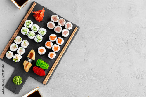 Maki sushi set served on black stone tray