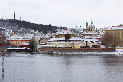 Snowy Prague Lesser Town with Prague Castle above River Vltava, Czech republic