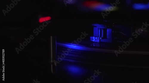 Disc spinning in turntable with blue light from disco night