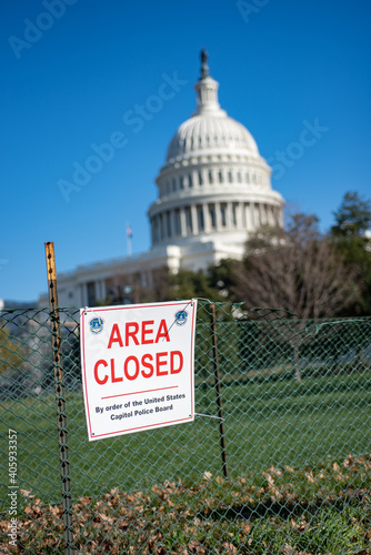 Washington, DC, USA - December, 23, 2020: Area Closed sigh on Fence on blureed United States Capitol Building background.