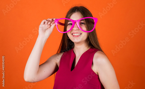 trendy looking kid girl with funny party glasses, having fun